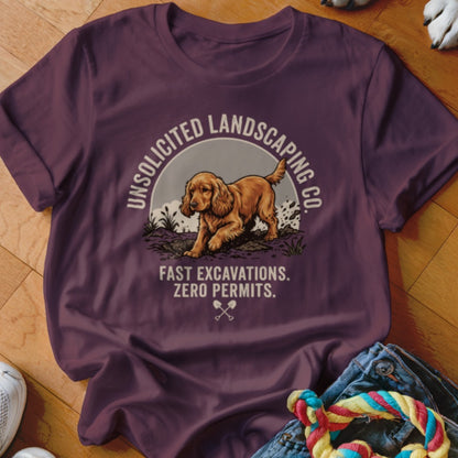 T-shirt with a spaniel digging dirt, "Unsolicited Landscaping Co." and "Fast Excavations. Zero Permits."