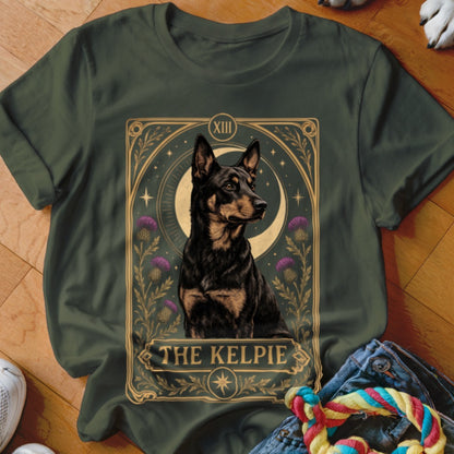 Dark green t-shirt featuring a tarot card graphic of a Kelpie dog with purple thistles.