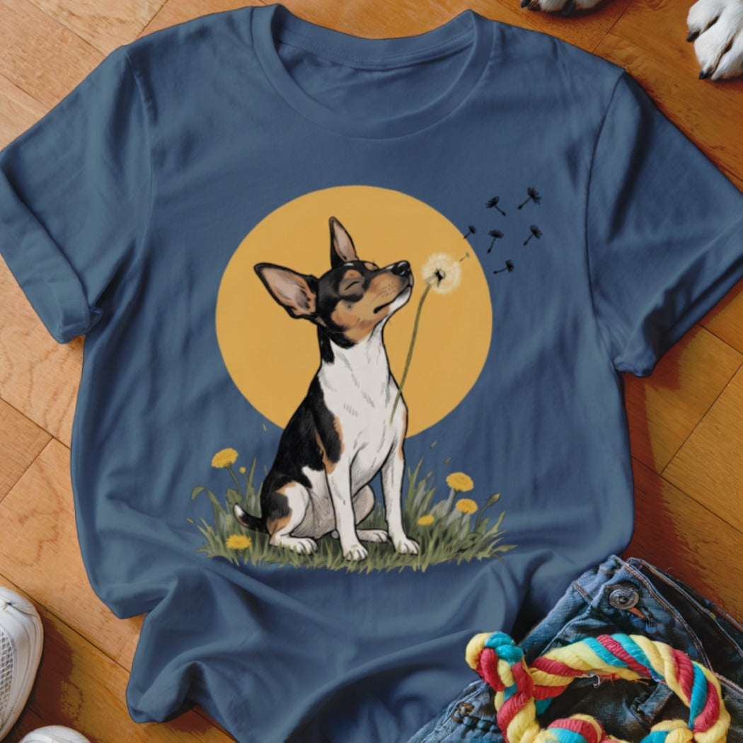 A dark blue t-shirt printed with an illustration of a dog blowing a dandelion.