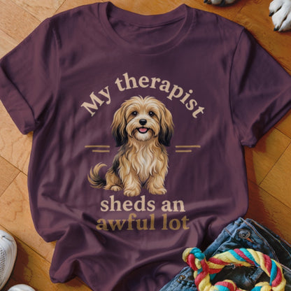 Maroon t-shirt with a fluffy dog and text "My therapist sheds an awful lot".