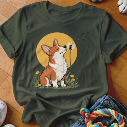 Dark green t-shirt featuring a graphic of a corgi blowing dandelion seeds against a yellow circle background.