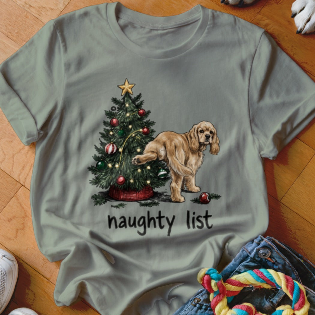 Light brown dog peeing on a Christmas tree with "naughty list" text.