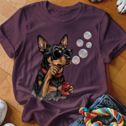 Dark purple t-shirt featuring a graphic of a dog wearing sunglasses and blowing bubbles.