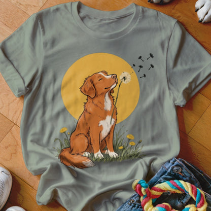 Sage green crewneck t-shirt featuring a brown dog blowing dandelion seeds against a yellow sun.