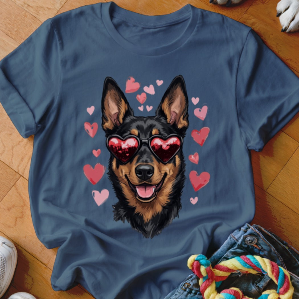 Blue t-shirt featuring an illustration of a black and tan dog wearing heart-shaped sunglasses surrounded by pink hearts.