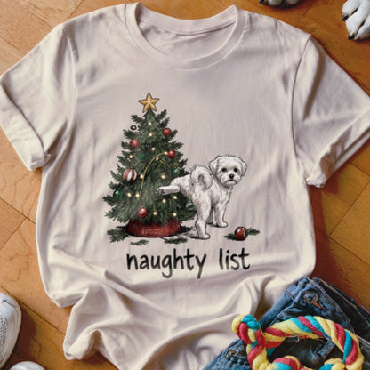White t-shirt with Christmas tree and dog illustration, text "naughty list".