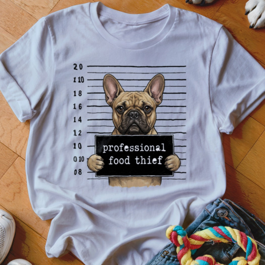 French bulldog mugshot with "professional food thief" sign on white t-shirt.