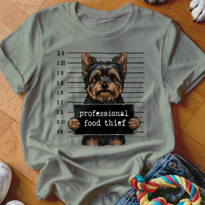 Yorkshire Terrier mugshot with "professional food thief" sign.
