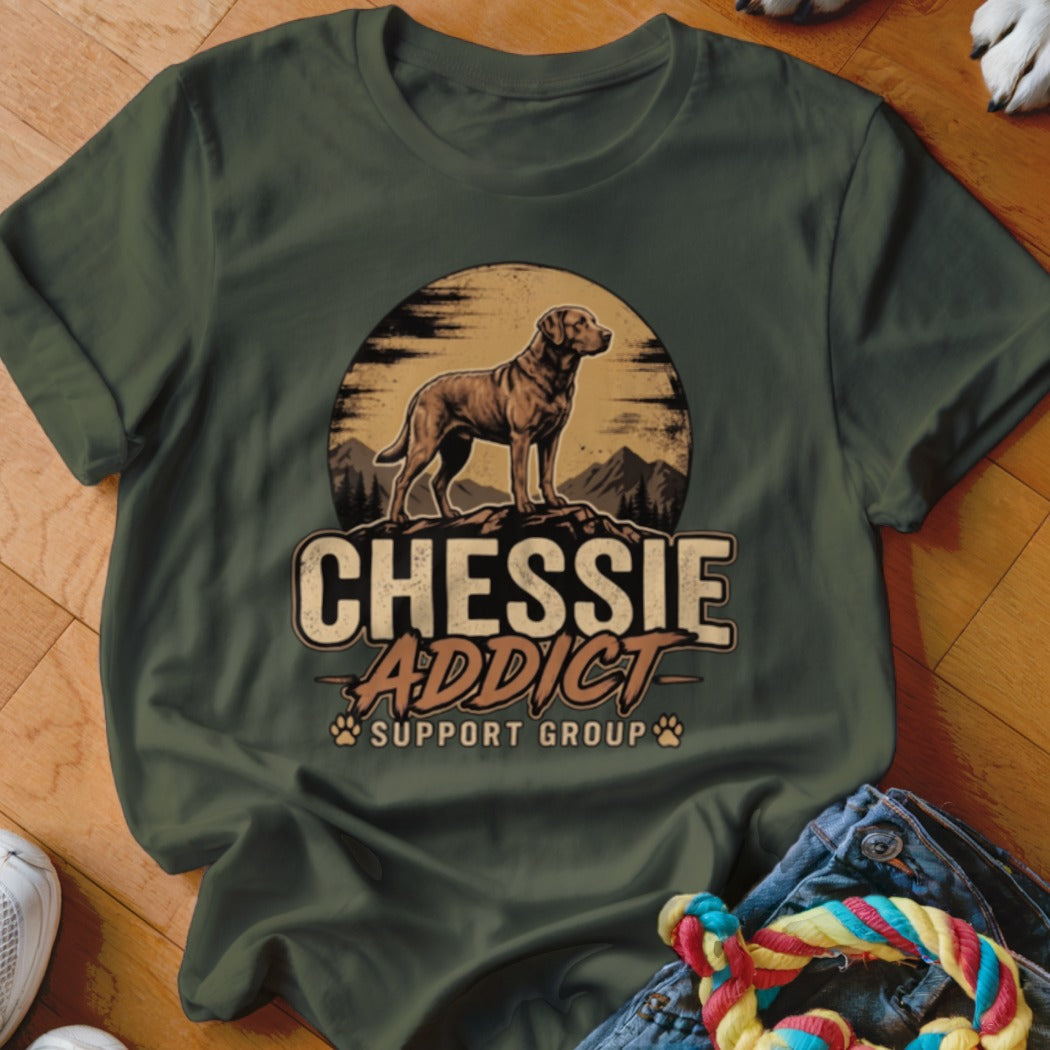 Dark green t-shirt with a vintage graphic of a dog, mountains, and the text Chessie Addict Support Group.