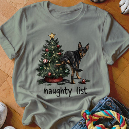 Dog lifting leg near Christmas tree with text "naughty list" below.