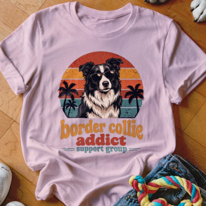 Light pink crew neck t-shirt featuring a retro graphic of a Border Collie wearing sunglasses.