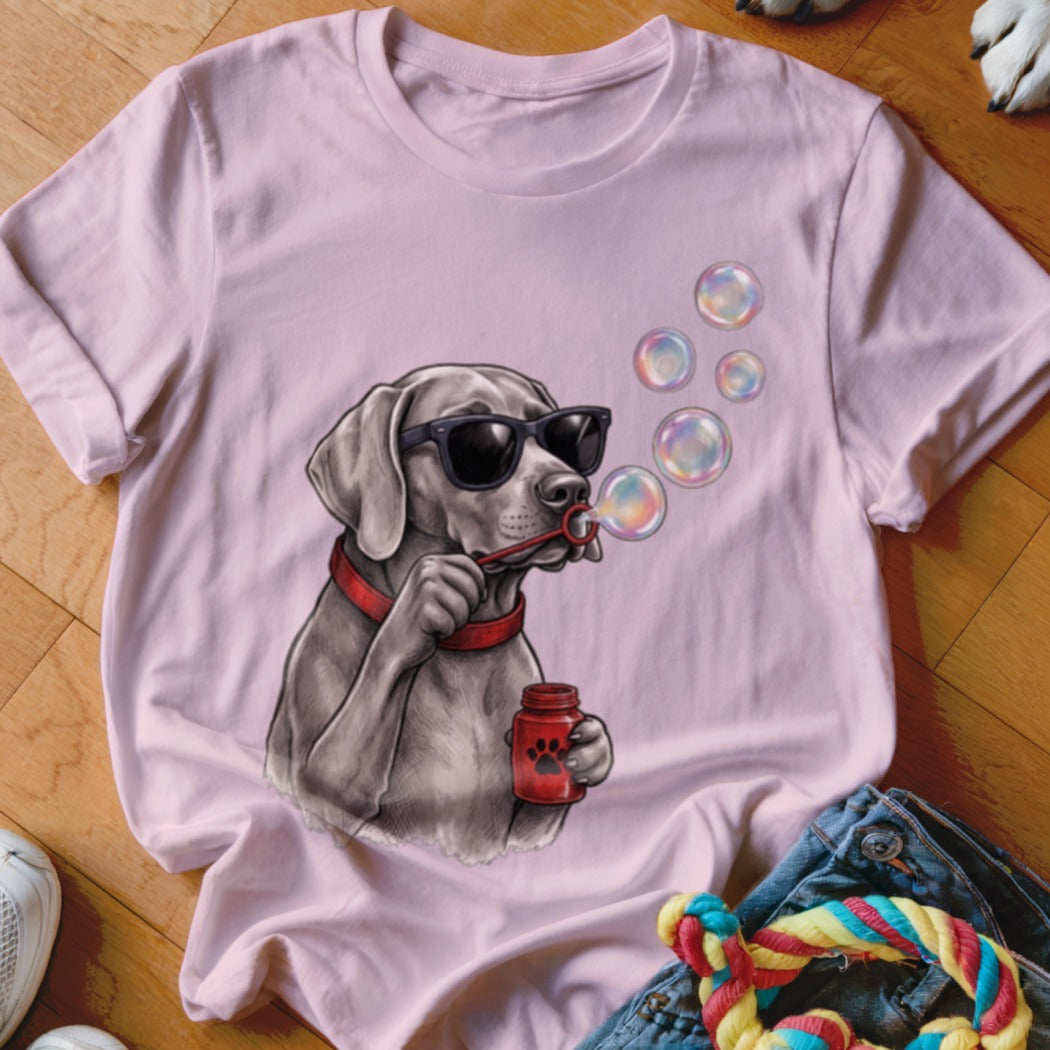 Light pink t-shirt featuring a graphic of a dog wearing sunglasses and blowing bubbles.