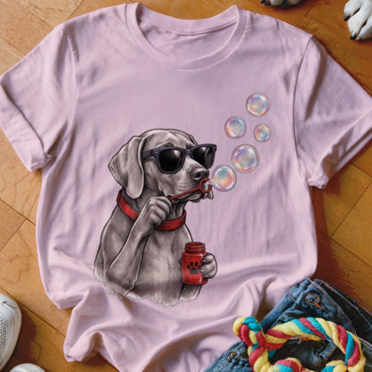 Light pink t-shirt featuring a graphic of a dog wearing sunglasses and blowing bubbles.