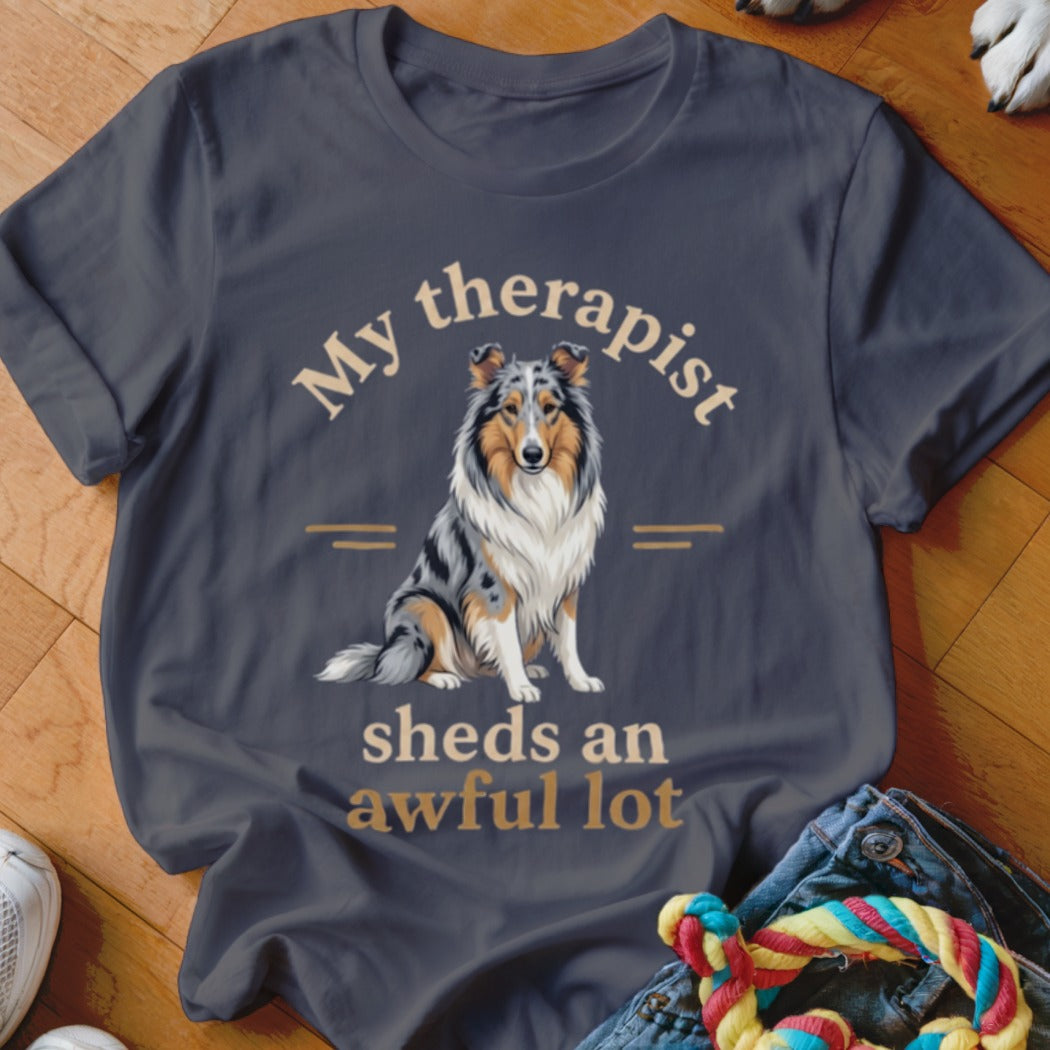 Dark t-shirt with a blue merle collie and text "My therapist sheds an awful lot".