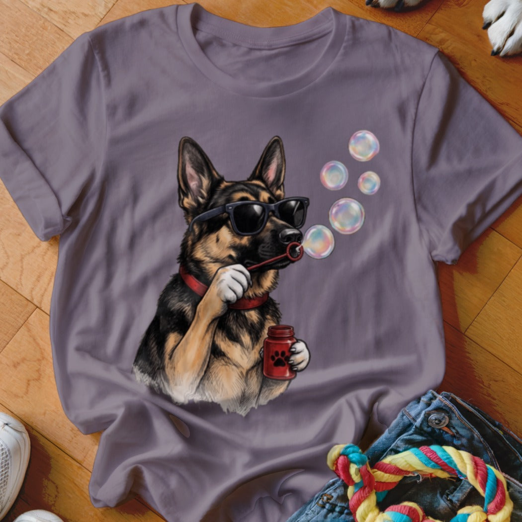 A grey t-shirt featuring a graphic of a German Shepherd wearing sunglasses and blowing bubbles.