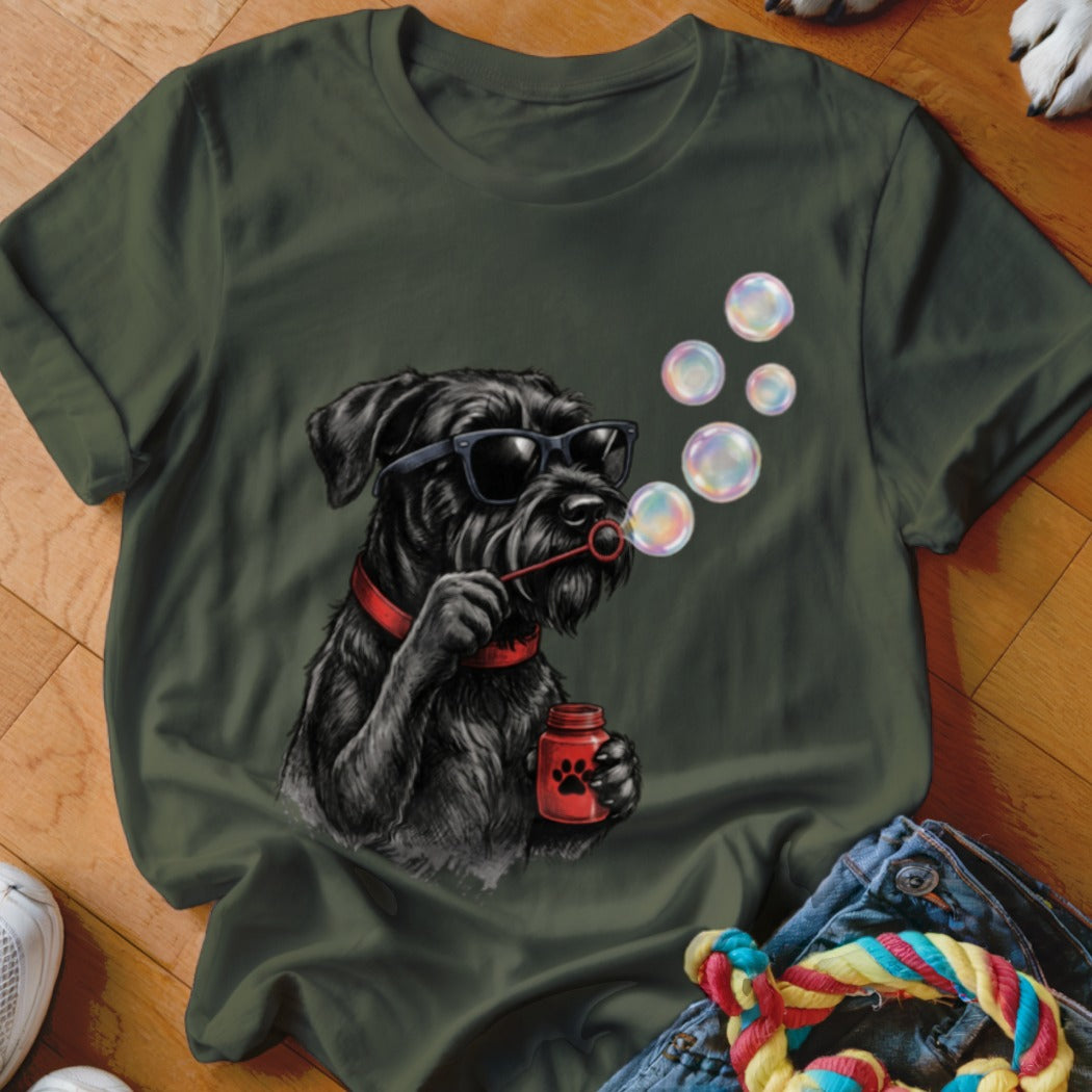 An olive green t-shirt featuring a graphic of a black dog wearing sunglasses while blowing soap bubbles.