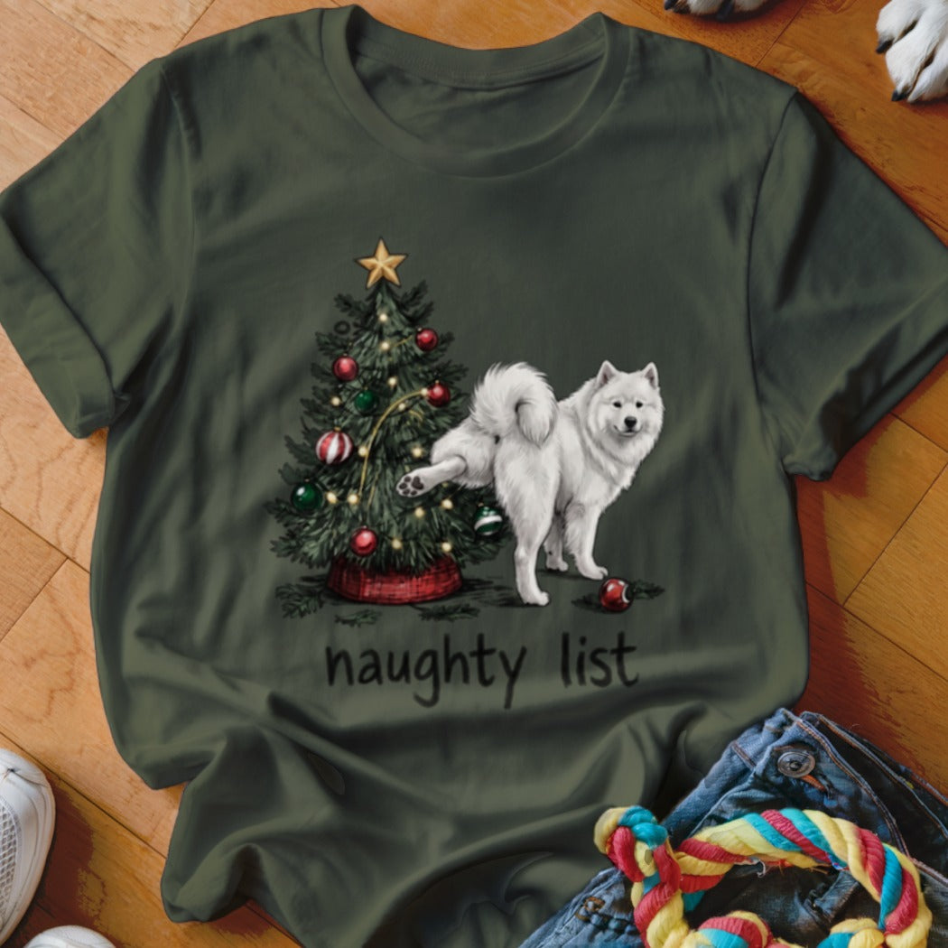 Dark green t-shirt featuring a Samoyed dog lifting its leg on a Christmas tree with the text "naughty list".