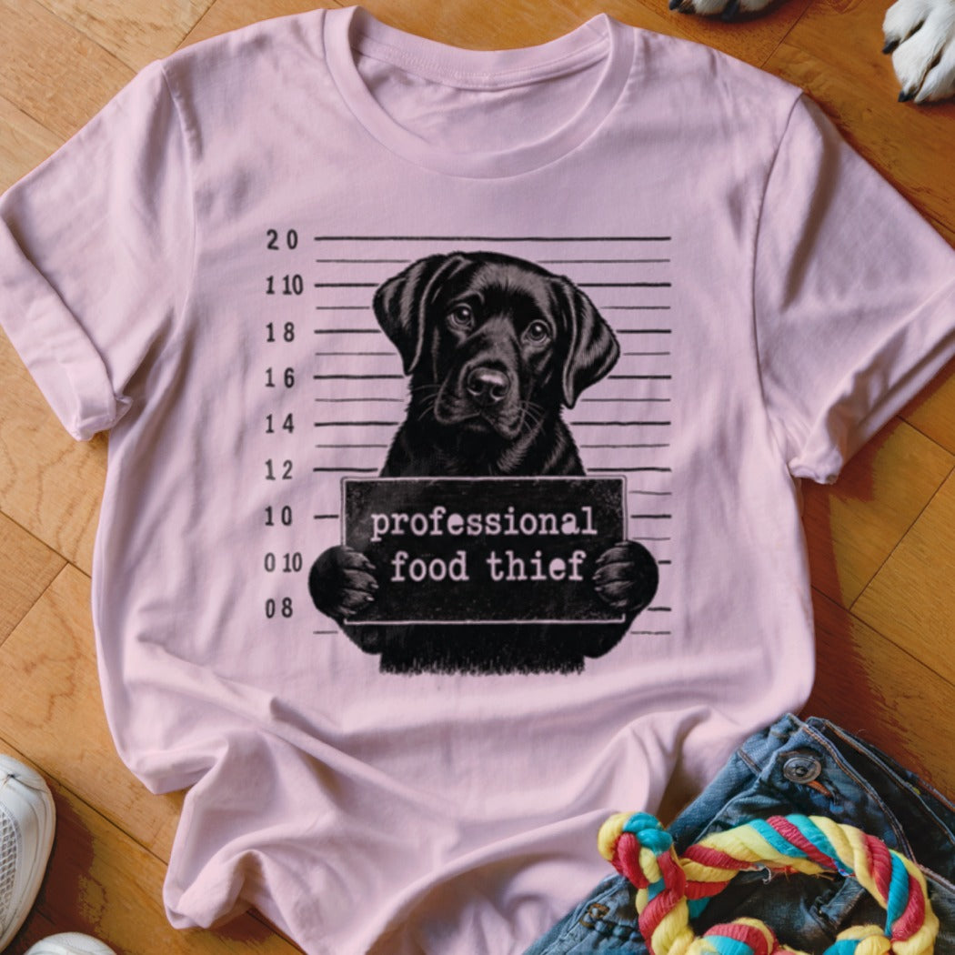 Pink t-shirt with black lab mugshot reading "professional food thief".