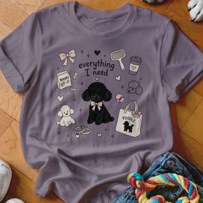 Purple shirt with a graphic that says "everything I need" and includes poodles, treats, and a purse.