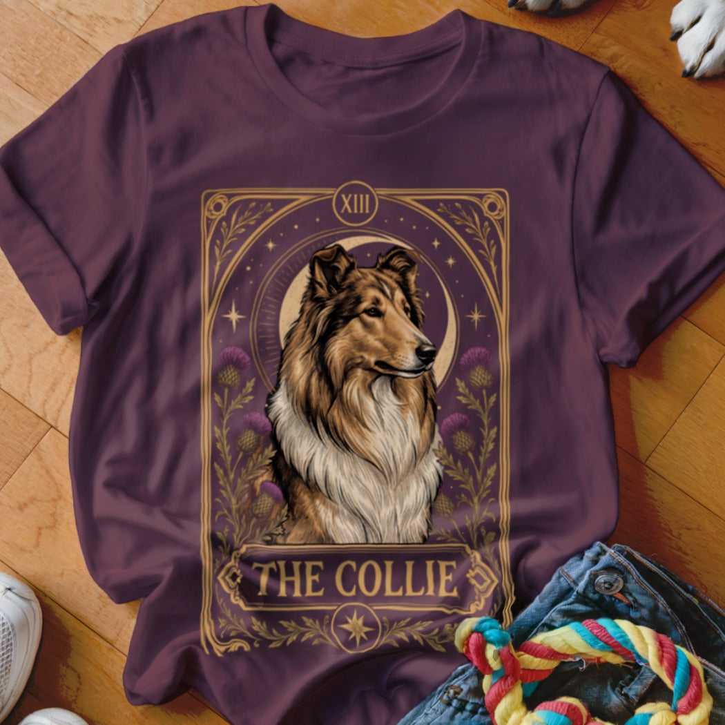 A dark purple t-shirt featuring a tarot-style graphic of a collie with thistles and the text The Collie.