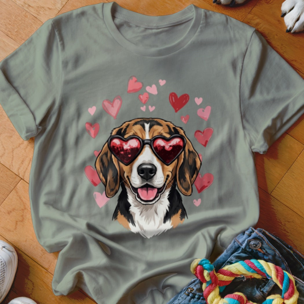 An olive green t-shirt featuring a graphic of a smiling beagle wearing heart-shaped sunglasses surrounded by pink and red hearts.