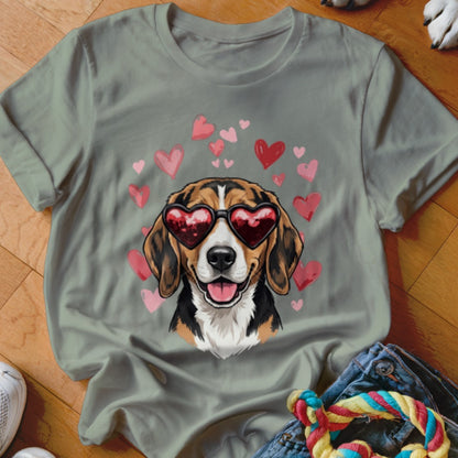 An olive green t-shirt featuring a graphic of a smiling beagle wearing heart-shaped sunglasses surrounded by pink and red hearts.