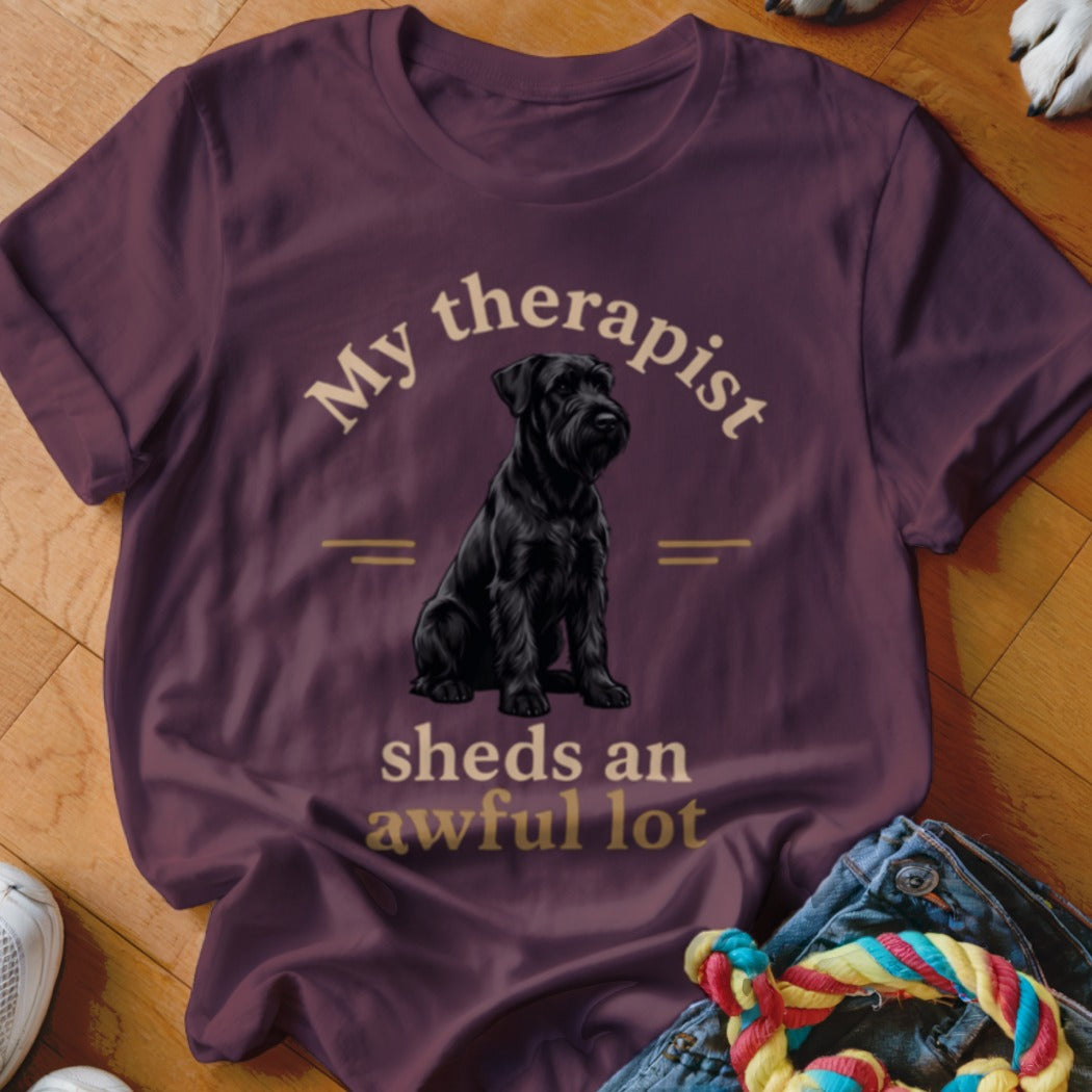Black schnauzer on a maroon t-shirt with text "My therapist sheds an awful lot".