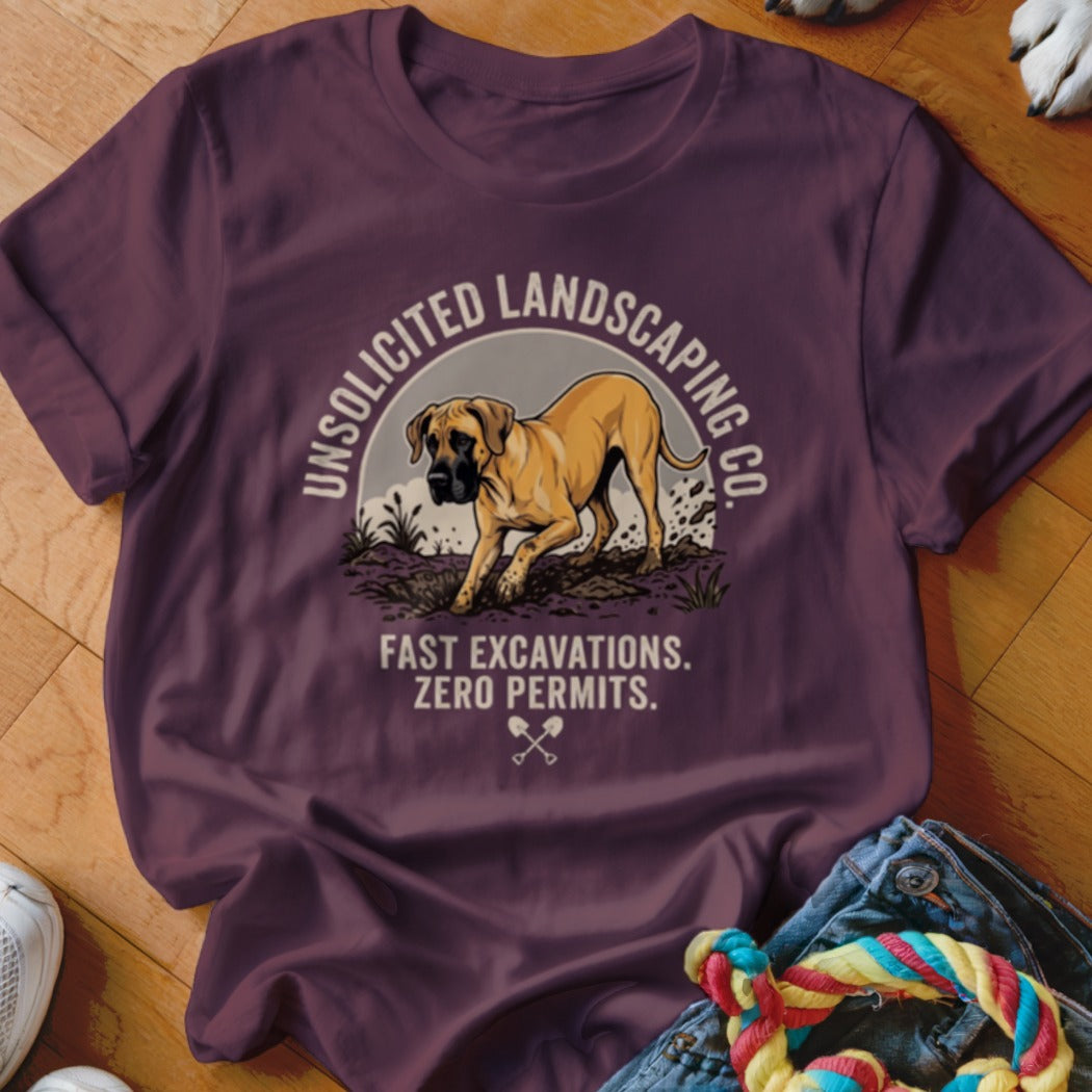 Burgundy t-shirt with a dog digging, "Unsolicited Landscaping Co." and "Fast Excavations. Zero Permits." text.