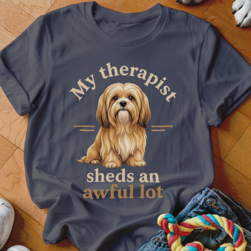 Dark grey t-shirt with a fluffy tan dog and text "My therapist sheds an awful lot".