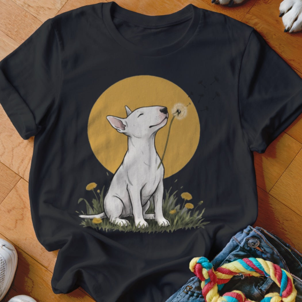 A black t-shirt featuring an illustration of a white bull terrier blowing a dandelion.