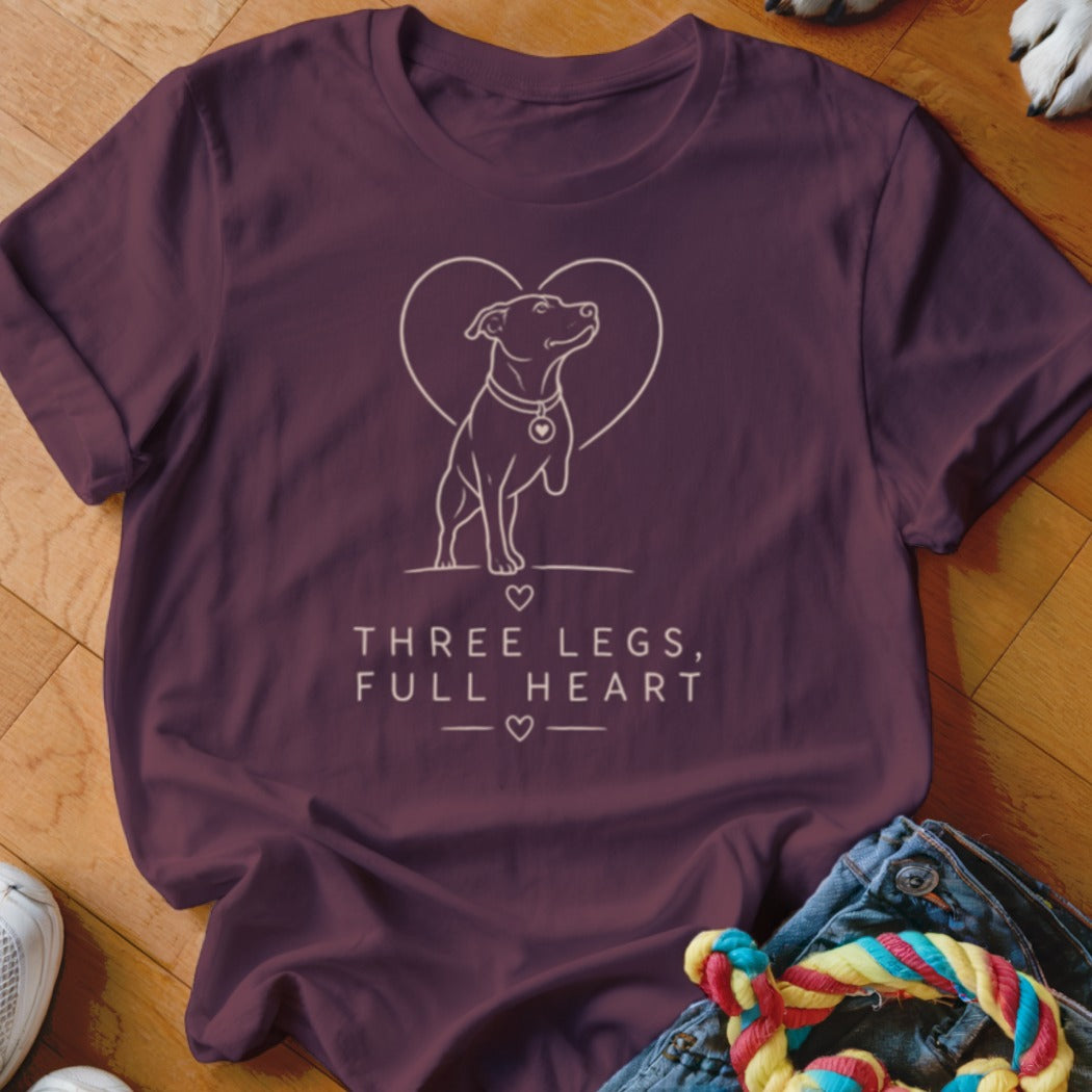 Maroon t-shirt with dog outline, heart, and text "THREE LEGS, FULL HEART".