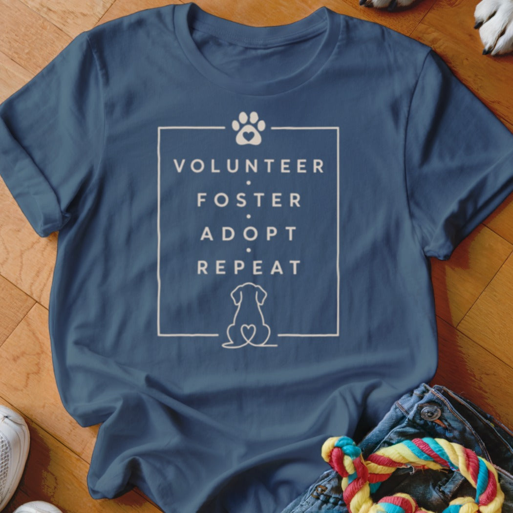 Blue t-shirt with text "Volunteer Foster Adopt Repeat" and dog graphic.
