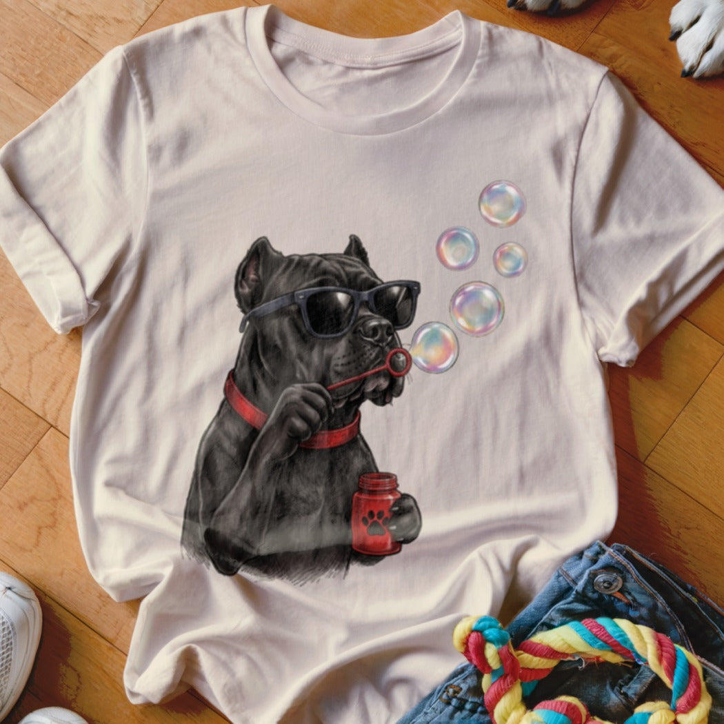 Light-colored crewneck t-shirt featuring a graphic of a black dog wearing sunglasses and blowing bubbles.