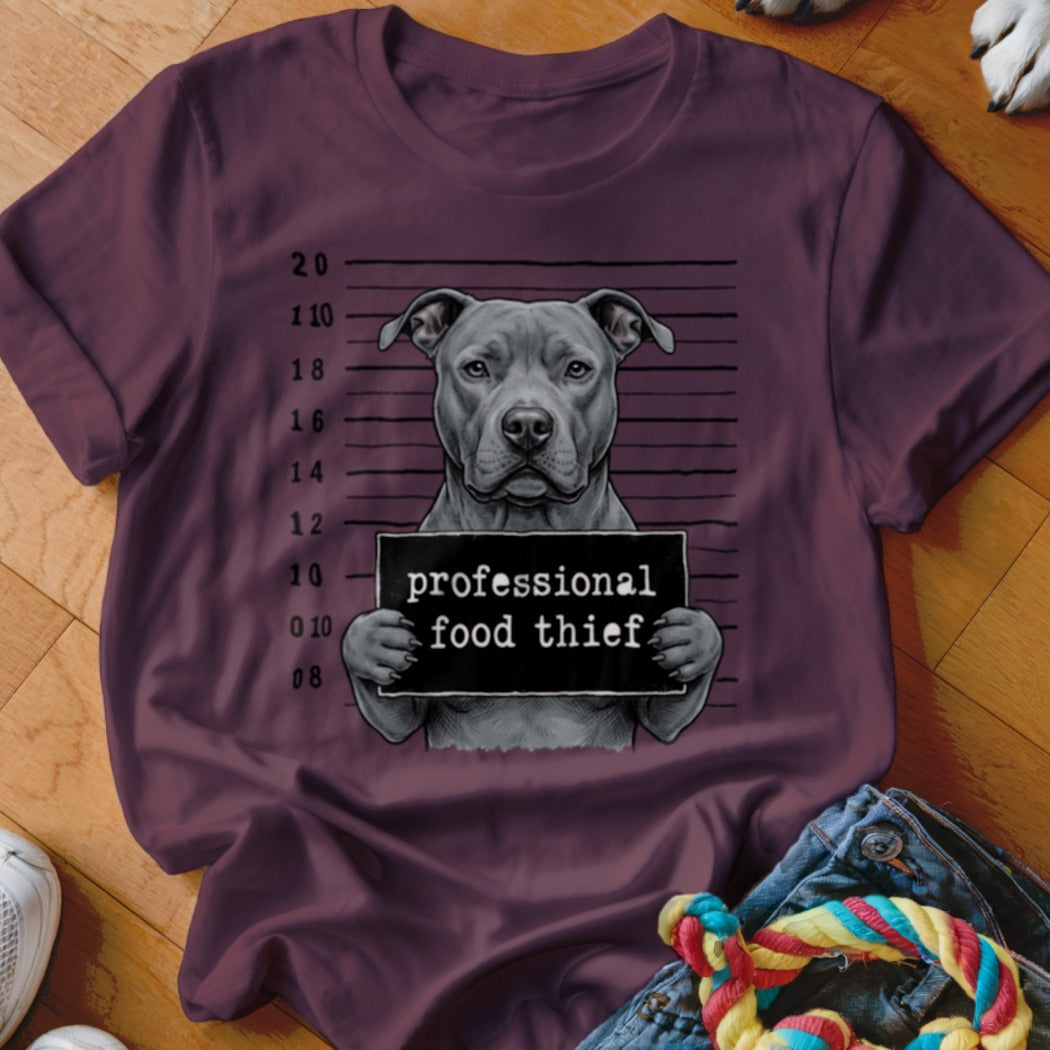 Pit bull mugshot with sign reading "professional food thief".