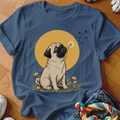 A blue t-shirt featuring an illustration of a pug blowing a dandelion against a yellow sun.
