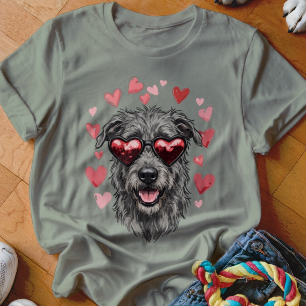Sage green t-shirt featuring a graphic of a scruffy gray dog wearing heart-shaped sunglasses, surrounded by pink hearts.