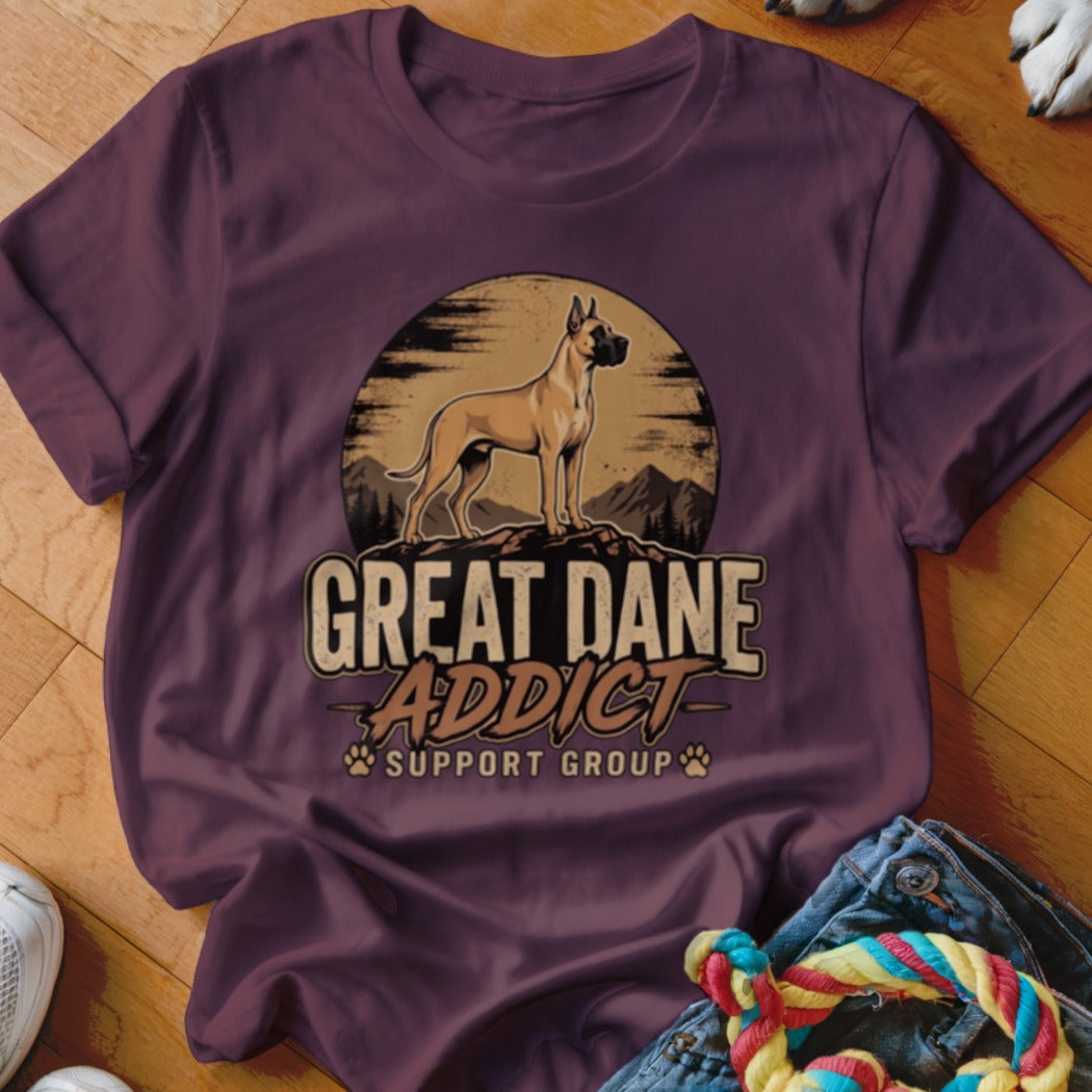 Maroon t-shirt featuring a graphic of a Great Dane standing on a rock against a sunset, with text reading GREAT DANE ADDICT SUPPORT GROUP.