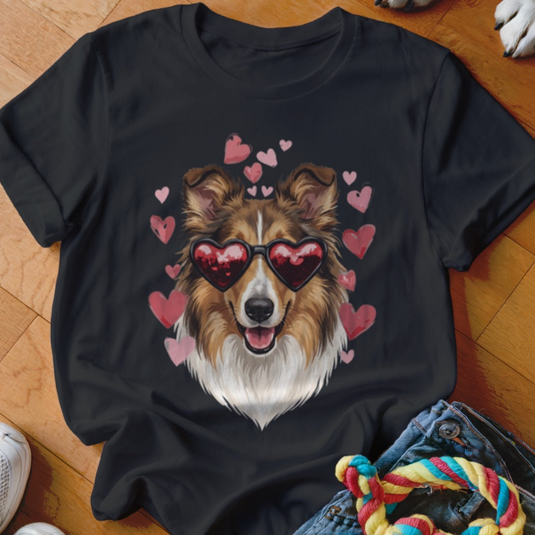 A black short-sleeved t-shirt featuring a graphic of a collie wearing heart-shaped sunglasses, surrounded by pink hearts.