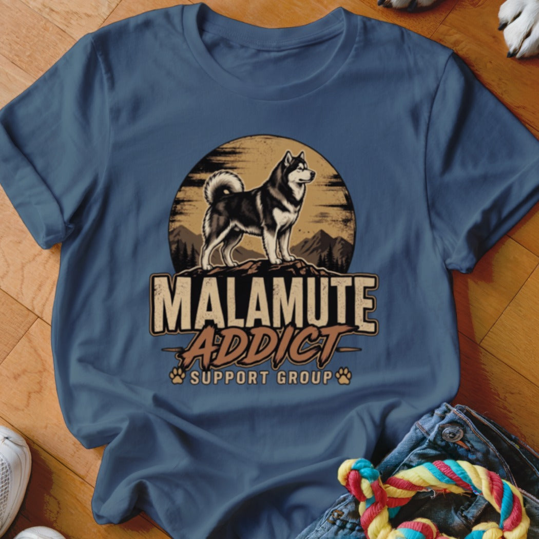 Blue crewneck t-shirt featuring a vintage graphic of a malamute on a mountain with text that reads Malamute Addict Support Group.