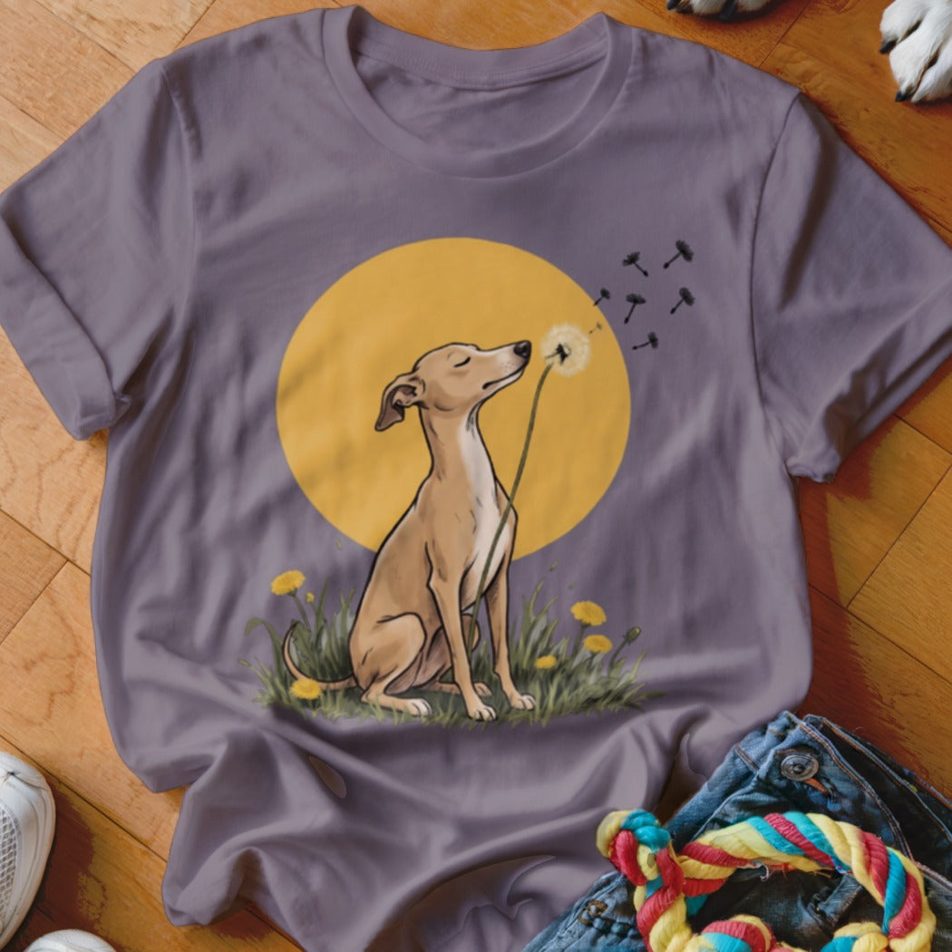 A grey crewneck t-shirt featuring an illustration of a dog blowing dandelion seeds against a yellow circle.