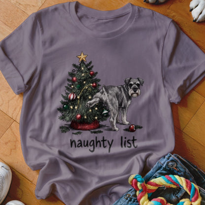 A mauve t-shirt features a graphic of a Schnauzer dog lifting its leg on a decorated Christmas tree, with the text "naughty list" below.