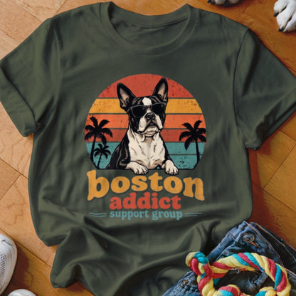 Dark green t-shirt featuring a retro graphic of a sunglasses-wearing Boston Terrier, palm trees, sunset, and text.