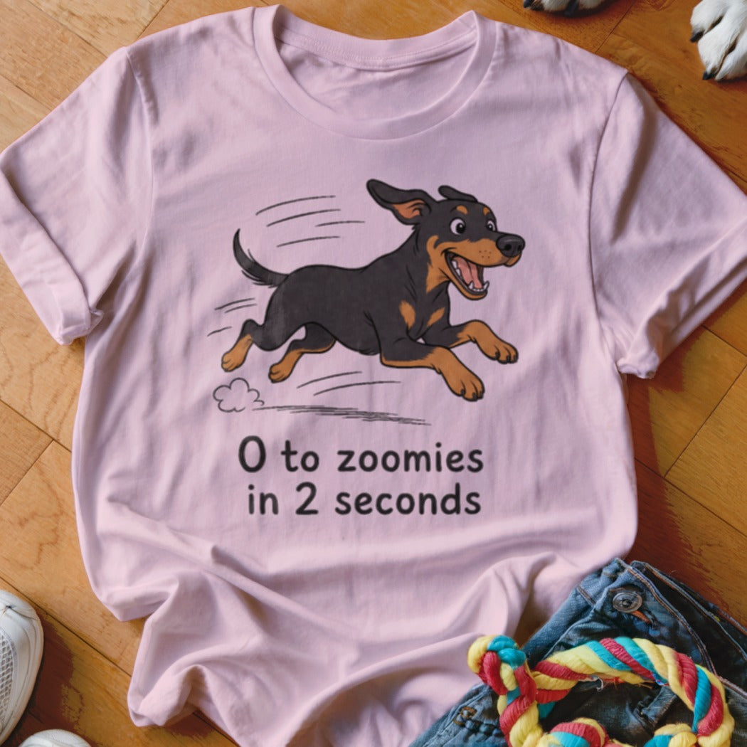 Pink t-shirt with cartoon dog running and text "0 to zoomies in 2 seconds".