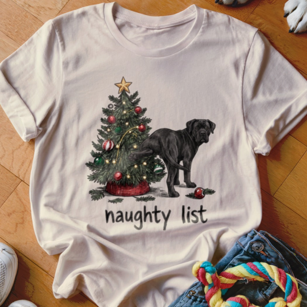Black dog next to Christmas tree with text "naughty list".