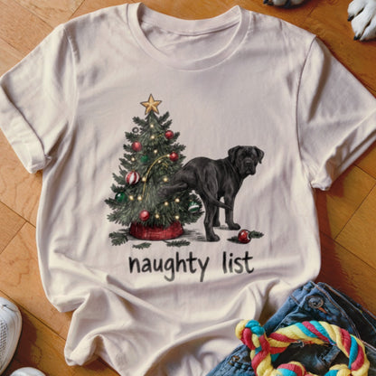 Black dog next to Christmas tree with text "naughty list".