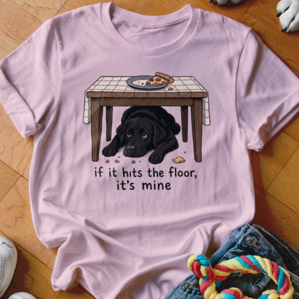 Pink t-shirt with illustration of black lab under table with pizza. Text reads, "if it hits the floor, it's mine."