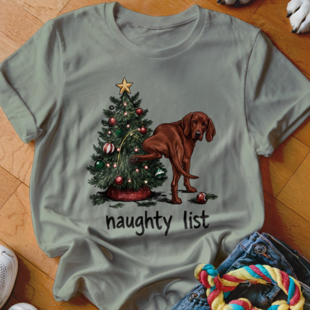 Brown dog lifting leg on Christmas tree with "naughty list" text below.