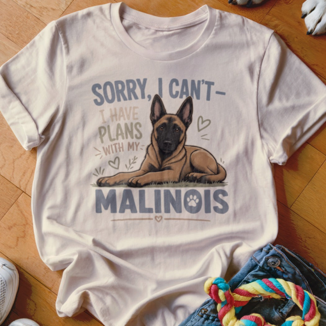 White t-shirt with a Malinois dog graphic and text "Sorry, I can't have plans with my Malinois."