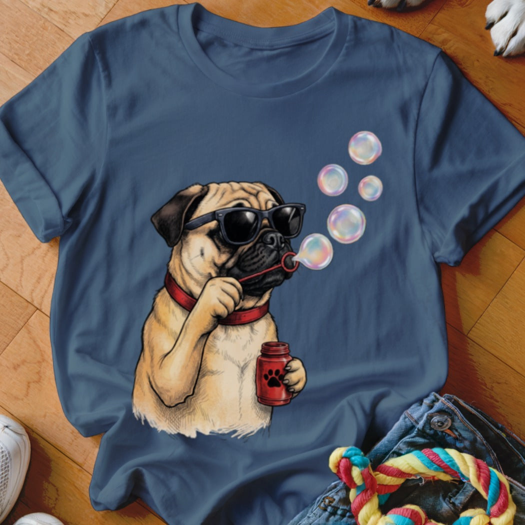 A blue t-shirt printed with a graphic of a pug wearing sunglasses and blowing bubbles.