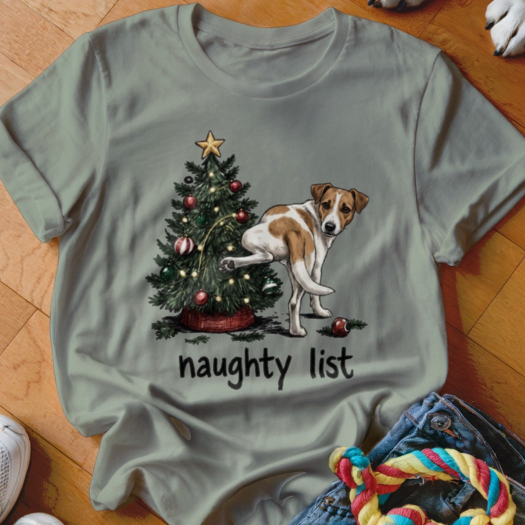 Dog lifting leg on Christmas tree with "naughty list" text below.